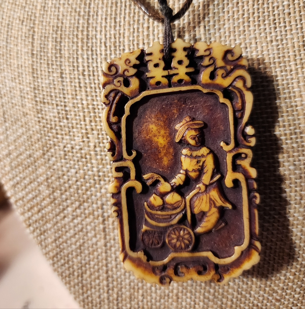 Vintage Buffalo Bone Hand Carved An Asian Scene Pendent.